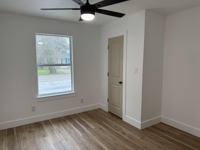 empty room with wood-type flooring and ceiling fan