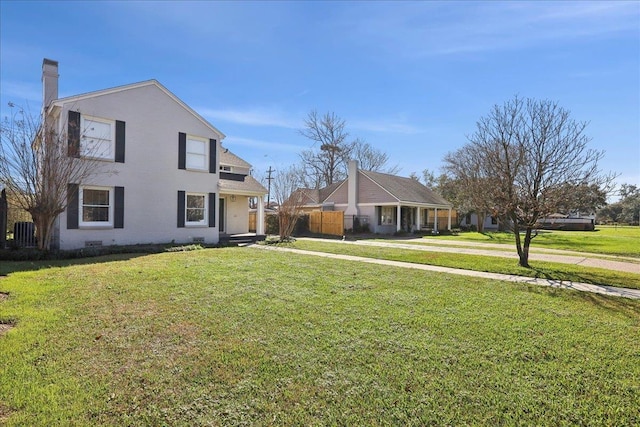 view of front facade with crawl space, central air condition unit, and a front lawn