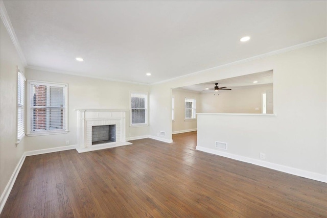 unfurnished living room with a brick fireplace, visible vents, dark wood finished floors, and baseboards