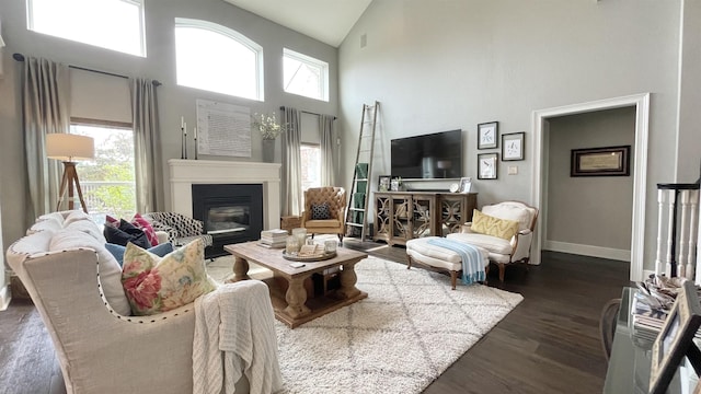 living room featuring high vaulted ceiling and dark hardwood / wood-style floors