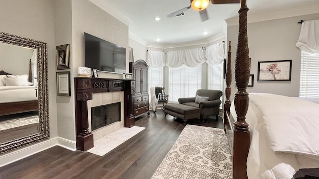 living room featuring ornamental molding, hardwood / wood-style floors, and a tile fireplace