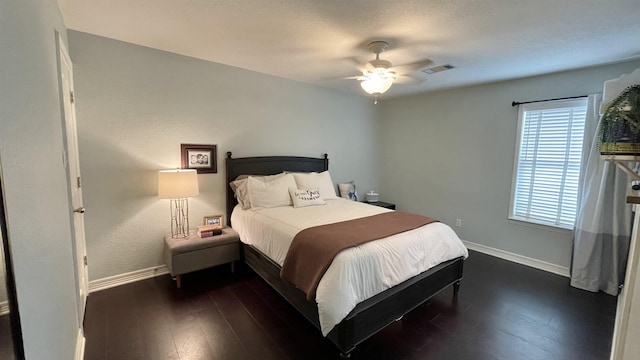 bedroom with dark wood-type flooring and ceiling fan