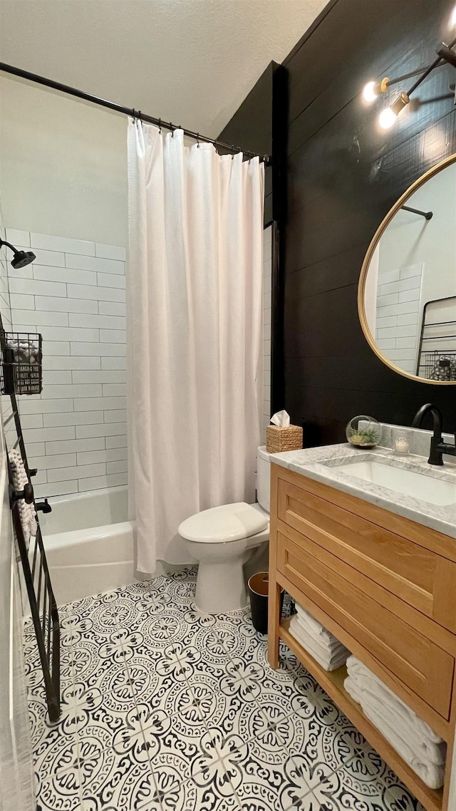 full bathroom with vanity, tile patterned floors, shower / bath combination with curtain, and toilet