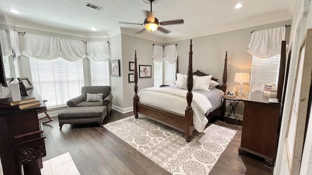 bedroom featuring ornamental molding, dark hardwood / wood-style floors, and ceiling fan