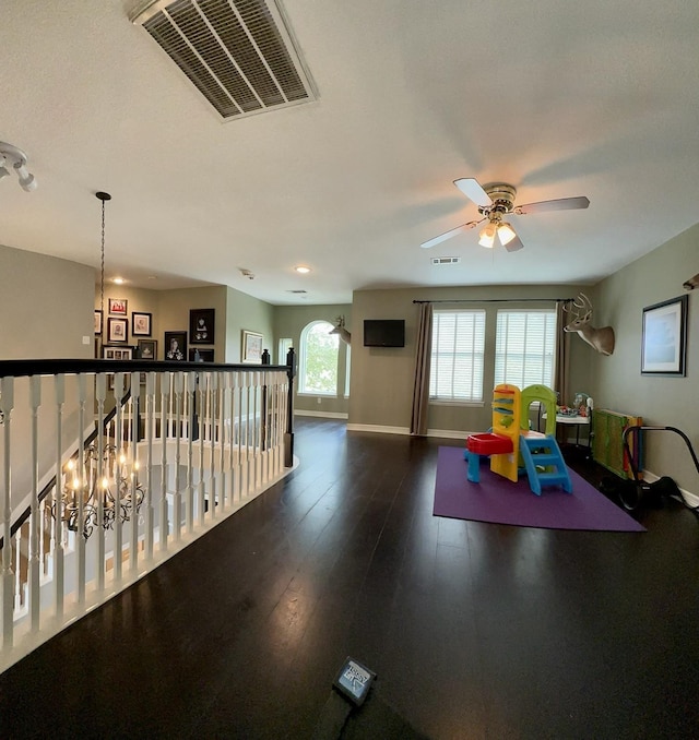 playroom featuring ceiling fan and dark hardwood / wood-style flooring