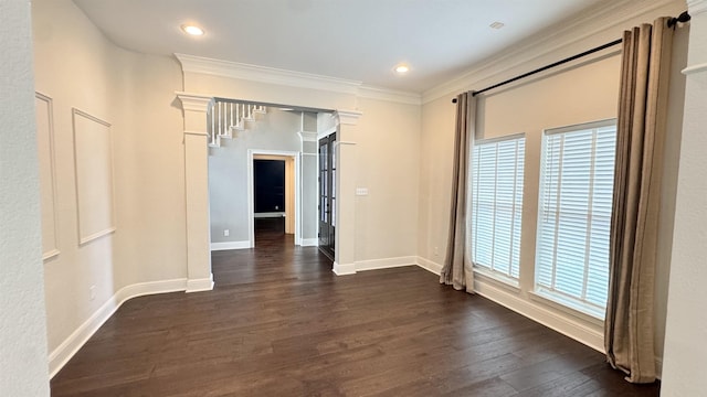 empty room with dark wood finished floors, baseboards, crown molding, and recessed lighting