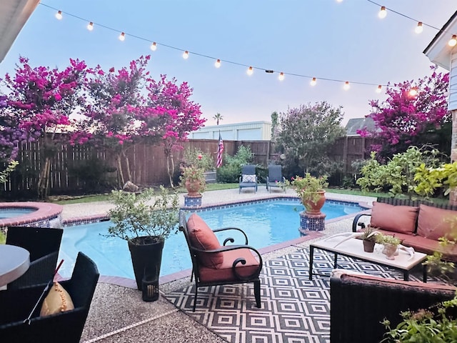 view of pool with an outdoor living space, a patio, and an in ground hot tub