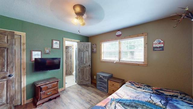 bedroom with ceiling fan and light hardwood / wood-style flooring