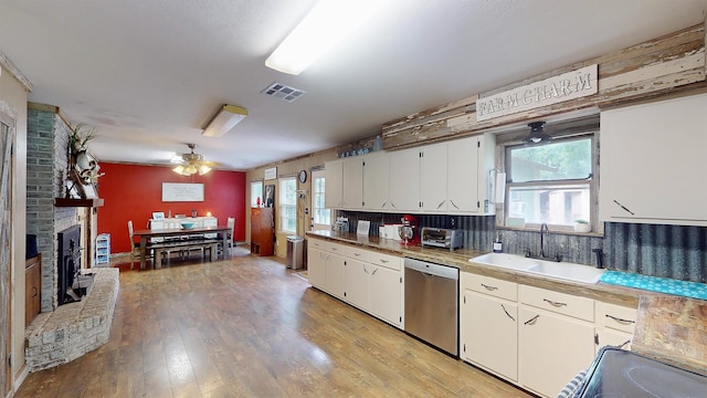 kitchen featuring dishwasher, sink, ceiling fan, light hardwood / wood-style floors, and white cabinetry