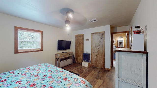 bedroom featuring ceiling fan and dark hardwood / wood-style flooring