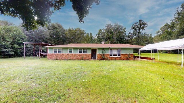 single story home featuring a front yard and a carport