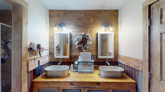 bathroom featuring wooden walls and vanity