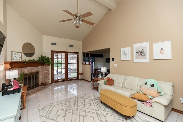 living area featuring light tile patterned floors, visible vents, ceiling fan, baseboards, and high vaulted ceiling