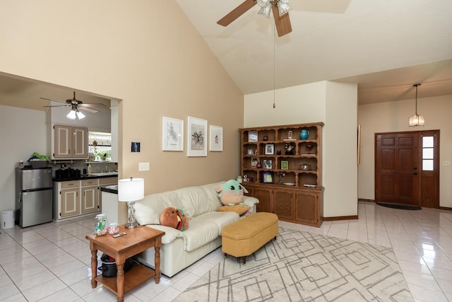 living room with light tile patterned floors, plenty of natural light, a ceiling fan, and high vaulted ceiling