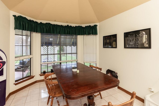 dining area with a healthy amount of sunlight, lofted ceiling, and baseboards