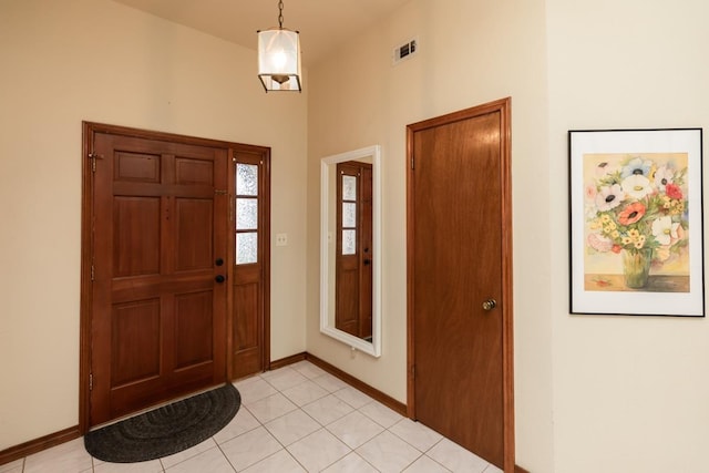 entryway with light tile patterned floors, visible vents, and baseboards