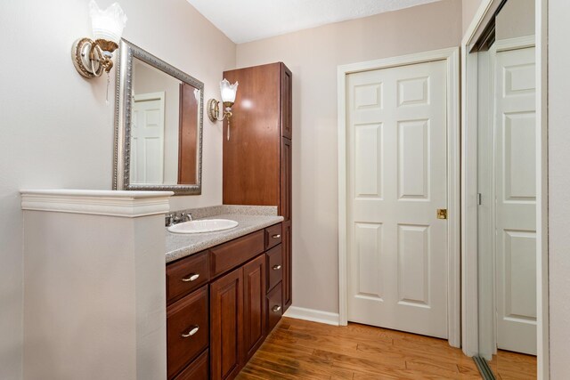 bathroom featuring vanity and hardwood / wood-style flooring