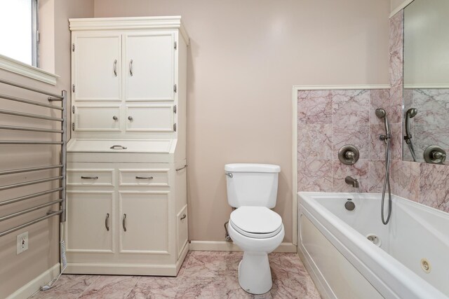 bathroom featuring a washtub and toilet