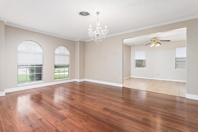 spare room with hardwood / wood-style flooring, ceiling fan with notable chandelier, crown molding, and a textured ceiling