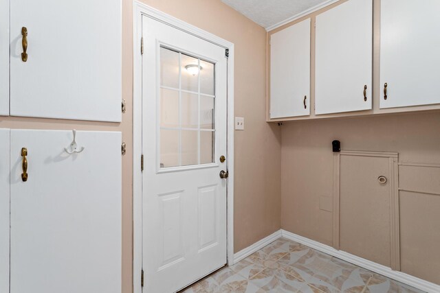 washroom with light tile patterned floors and cabinets