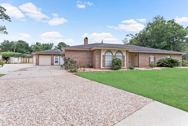 single story home featuring a front yard and a garage