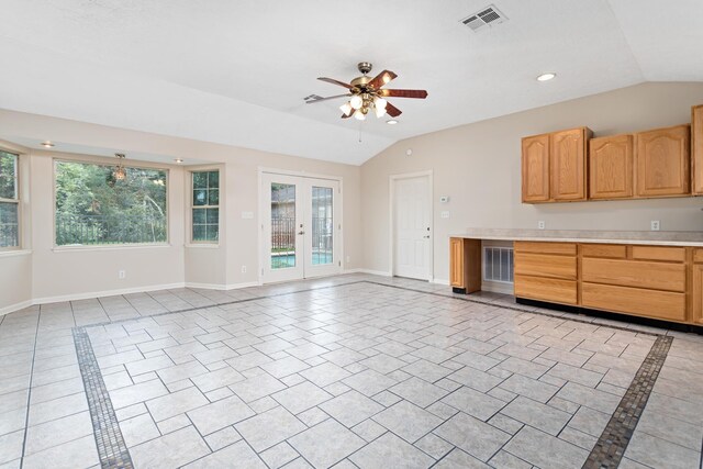 kitchen with ceiling fan, french doors, light tile patterned floors, and lofted ceiling