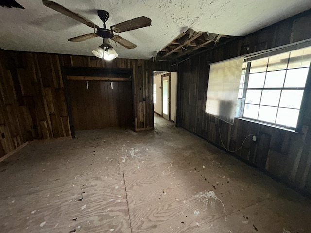 interior space with ceiling fan