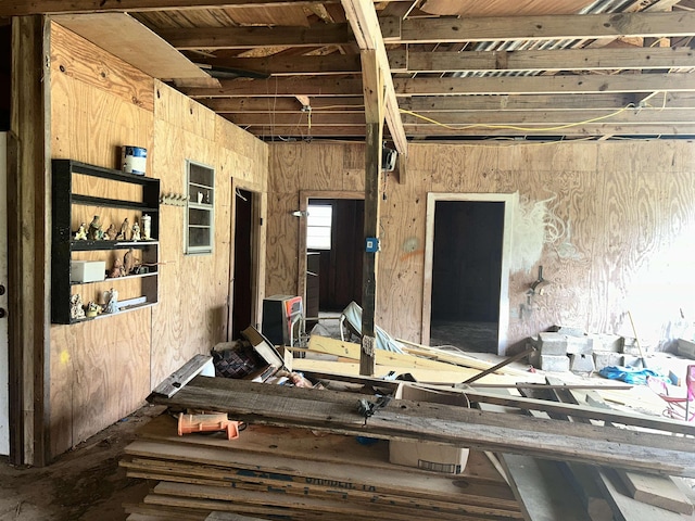 miscellaneous room featuring wood walls