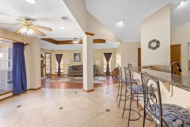 interior space featuring ceiling fan, plenty of natural light, and light tile patterned floors