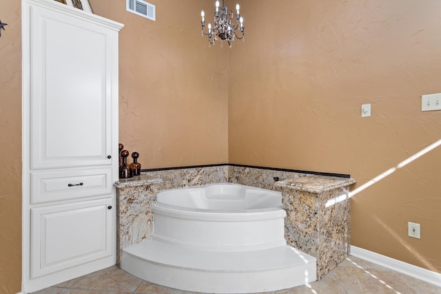 bathroom featuring a bath and a notable chandelier