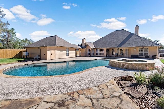 view of pool featuring a patio area and an in ground hot tub