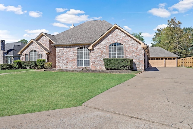 view of front of home with a garage and a front lawn