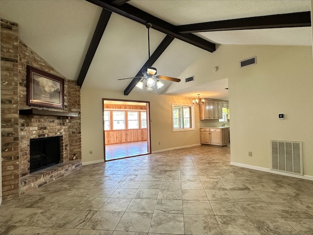 unfurnished living room with a brick fireplace, beam ceiling, ceiling fan with notable chandelier, and high vaulted ceiling