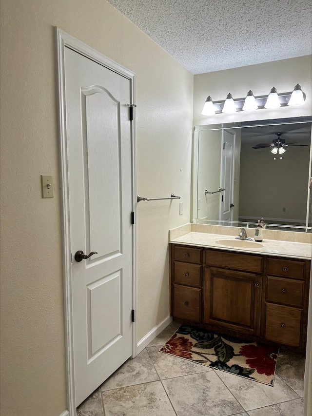 bathroom with vanity, tile patterned flooring, and a textured ceiling