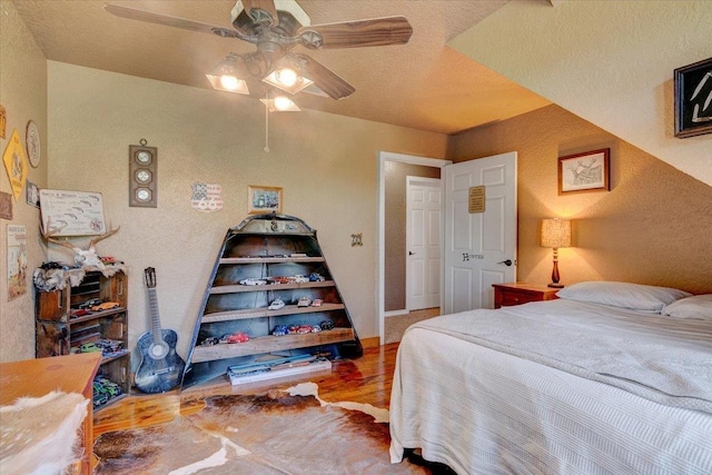 bedroom featuring ceiling fan and hardwood / wood-style flooring