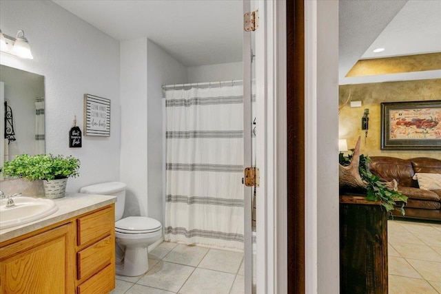 bathroom featuring tile patterned flooring, vanity, toilet, and curtained shower