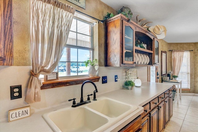 kitchen with light tile patterned floors and sink