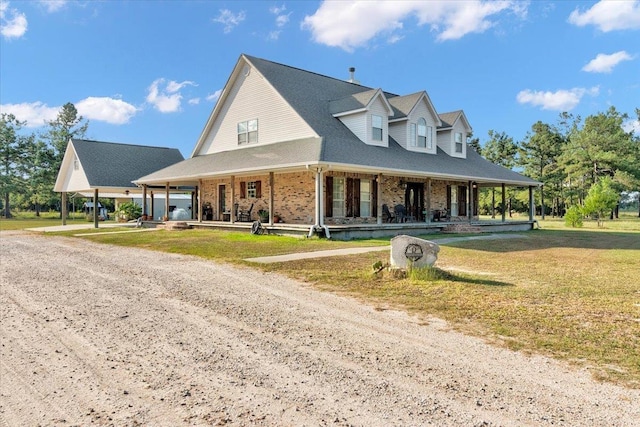 view of front of home with covered porch and a front lawn