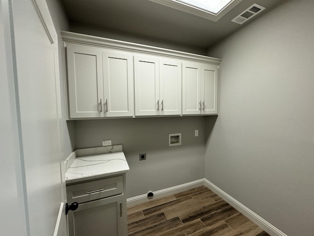 washroom featuring cabinets, washer hookup, dark wood-type flooring, and electric dryer hookup