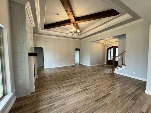 unfurnished living room featuring coffered ceiling, beamed ceiling, a chandelier, a fireplace, and ornamental molding