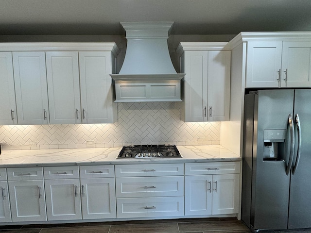 kitchen with custom exhaust hood, white cabinetry, and stainless steel appliances