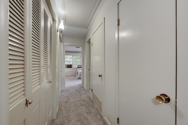 hallway with light colored carpet