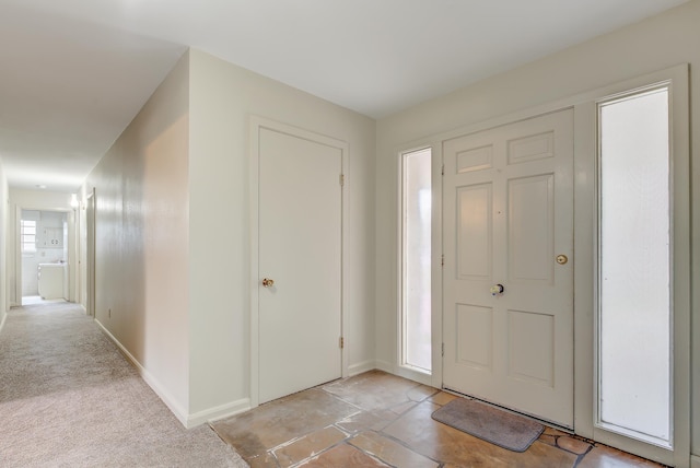 view of carpeted foyer