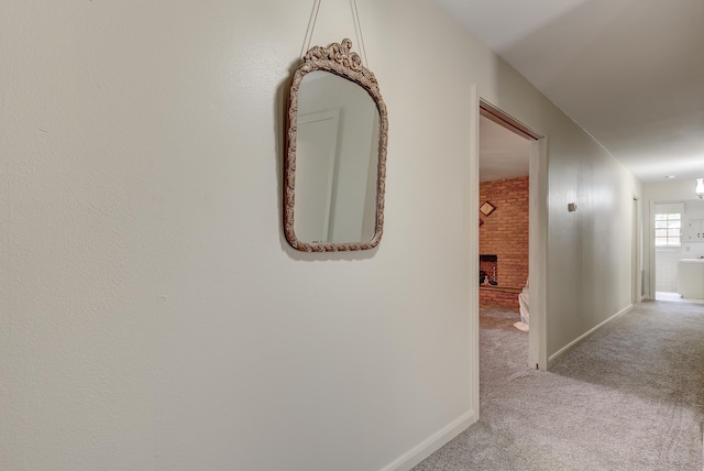 hallway with light colored carpet