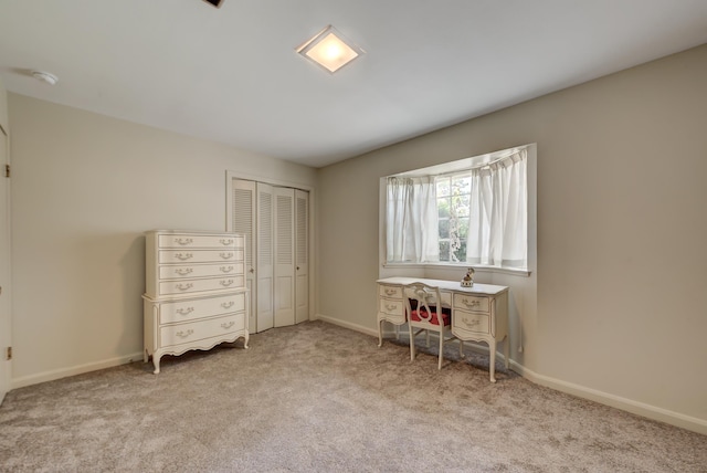 unfurnished bedroom with light carpet and a closet