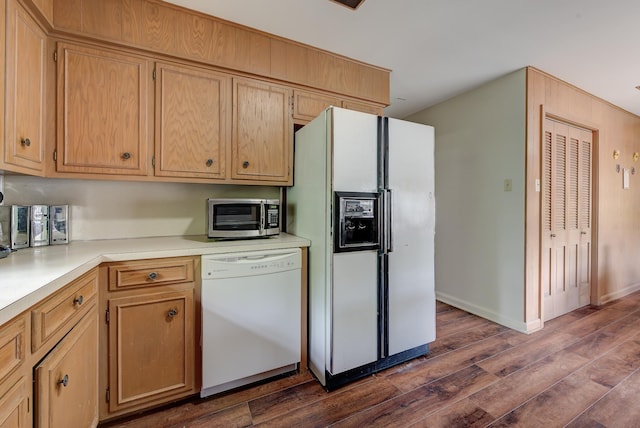 kitchen with dark hardwood / wood-style floors and white appliances