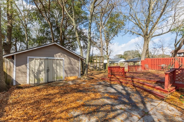 wooden terrace featuring a storage shed