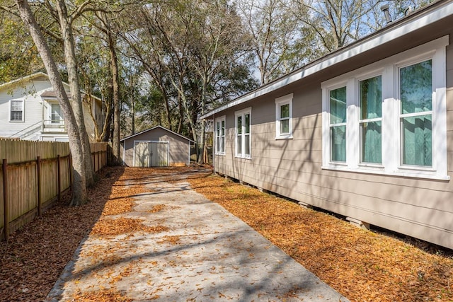 view of property exterior with a storage unit