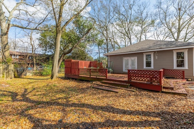 view of yard with a wooden deck and french doors