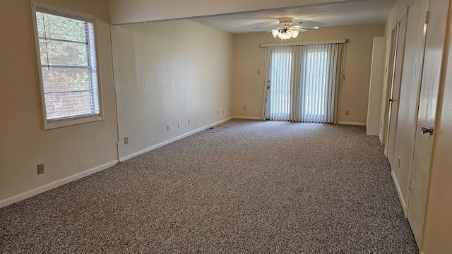 unfurnished room featuring carpet flooring, a wealth of natural light, and ceiling fan